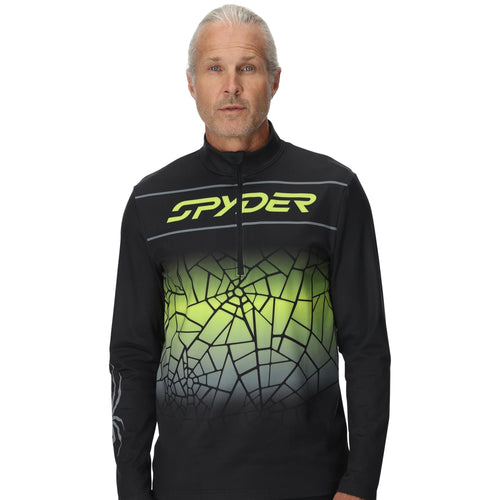 Person wearing a black and green Spyder jacket on a white background