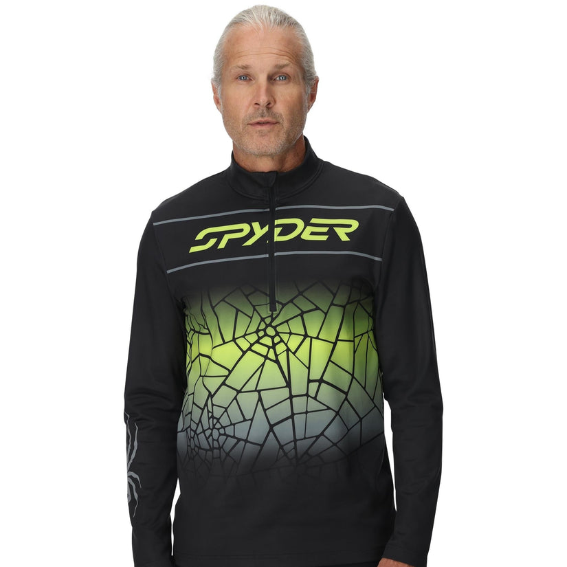 Person wearing a black and green Spyder jacket on a white background