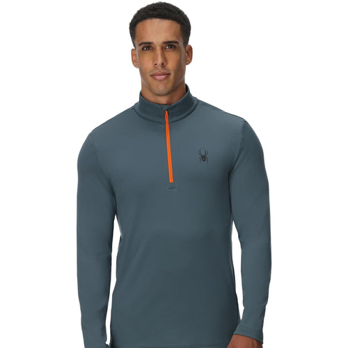 Man wearing a gray long-sleeve shirt with an orange zipper on a white background