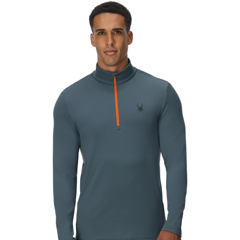Man wearing a gray long-sleeve shirt with an orange zipper on a white background