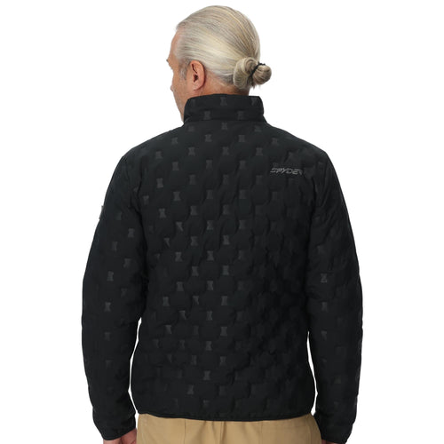 Man wearing a black quilted jacket with a pattern on a white background