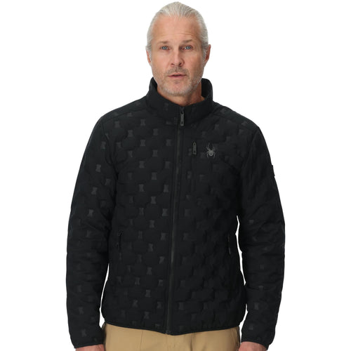 Man wearing a black quilted jacket with a pattern on a white background