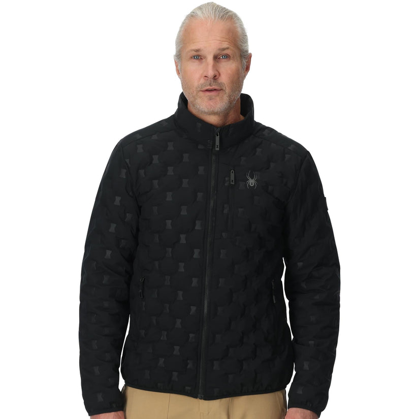 Man wearing a black quilted jacket with a pattern on a white background