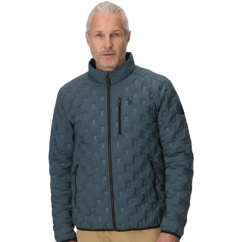 Man wearing a blue quilted jacket on a white background
