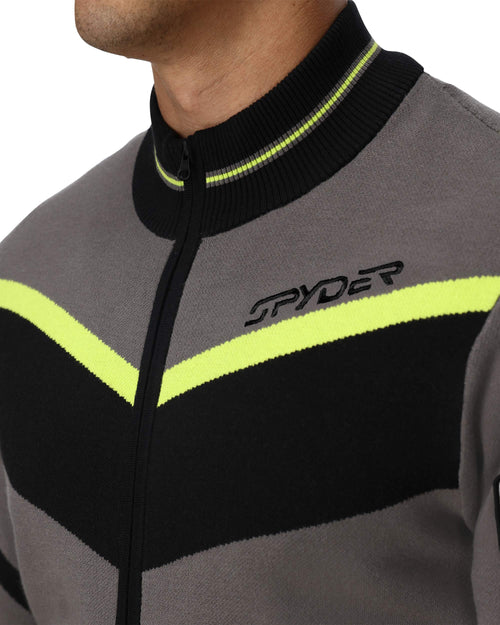 Man wearing a gray jacket with black and yellow accents on a white background