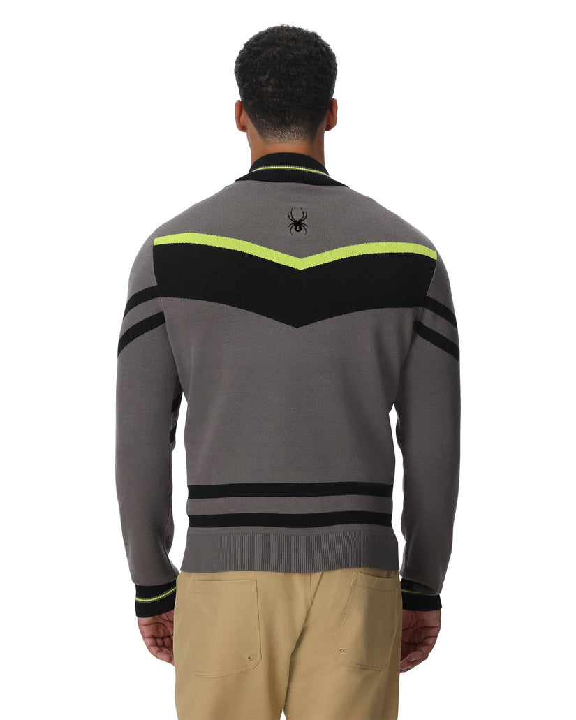 Man wearing a gray sweater with black and yellow stripes on a white background