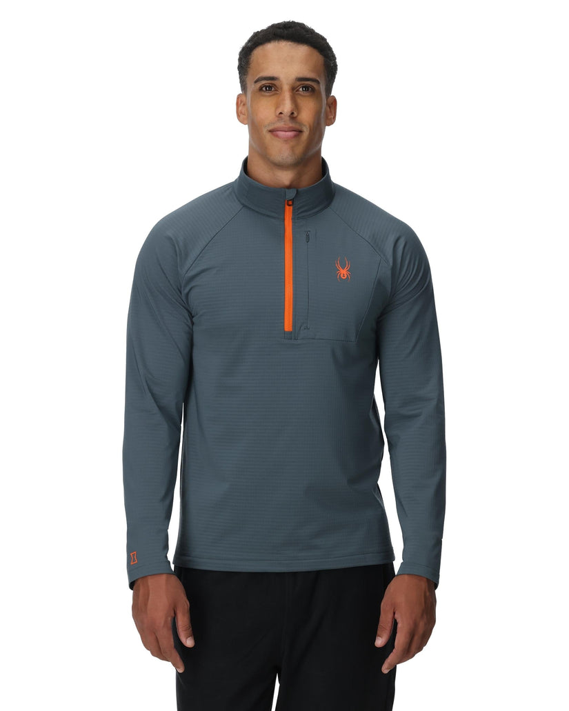 Man wearing a gray long-sleeve shirt with an orange zipper on a white background