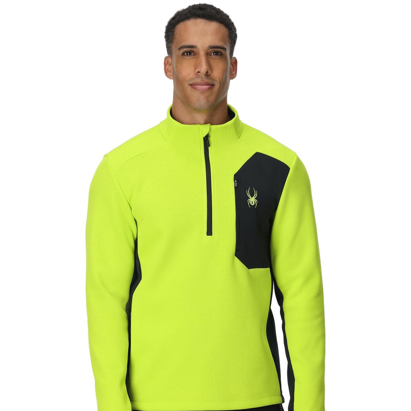 Man wearing a bright yellow and black jacket on a white background