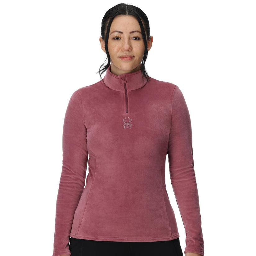 Woman wearing a pink long-sleeve shirt with a brand logo on a white background