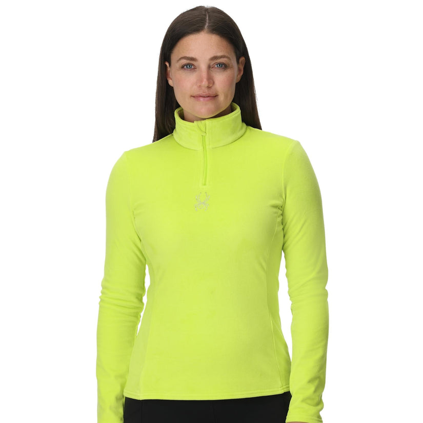 Woman wearing a bright yellow long-sleeve athletic top on a white background
