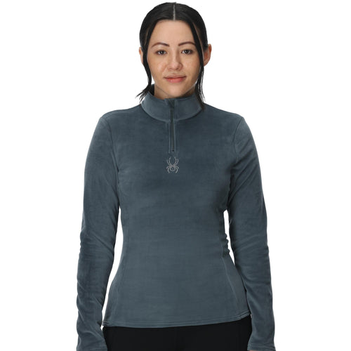 Woman wearing a gray long-sleeve shirt with a brand logo on a white background