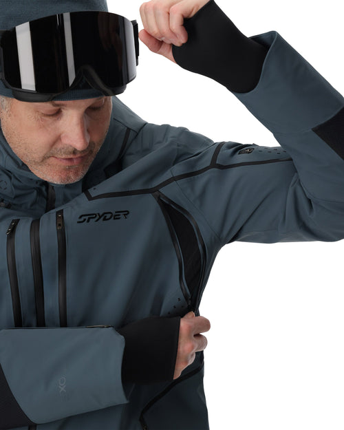 Man wearing a gray ski jacket with black accents on a white background