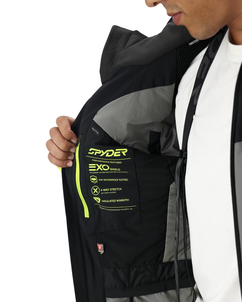 Person wearing a black jacket with Spyder branding on a white background