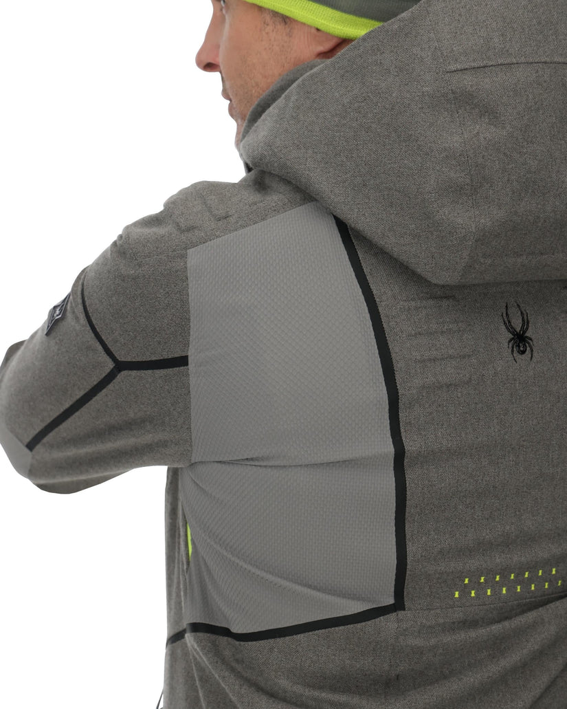 Person wearing a gray jacket with a Spyder logo, showing extra stretch in the shoulder area.