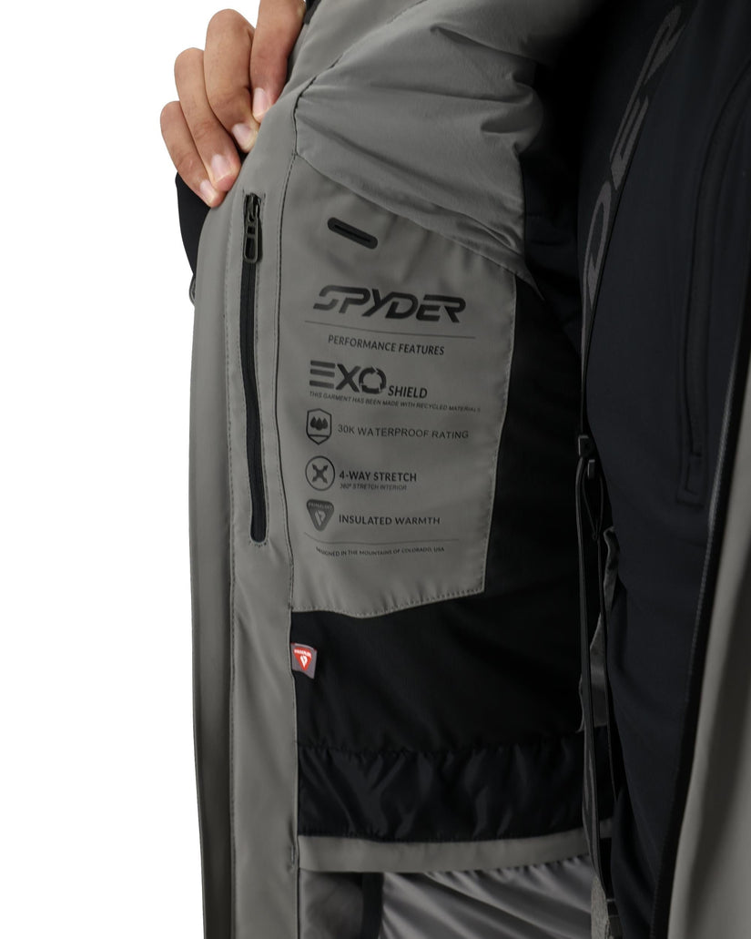 Close-up of a gray jacket with Spyder branding and EXO Shield feature label.