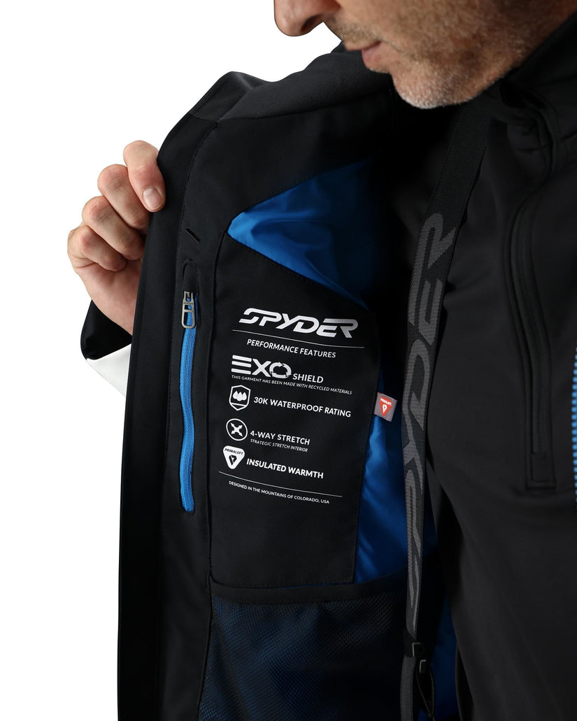 Person wearing a black jacket with Spyder branding and feature label.