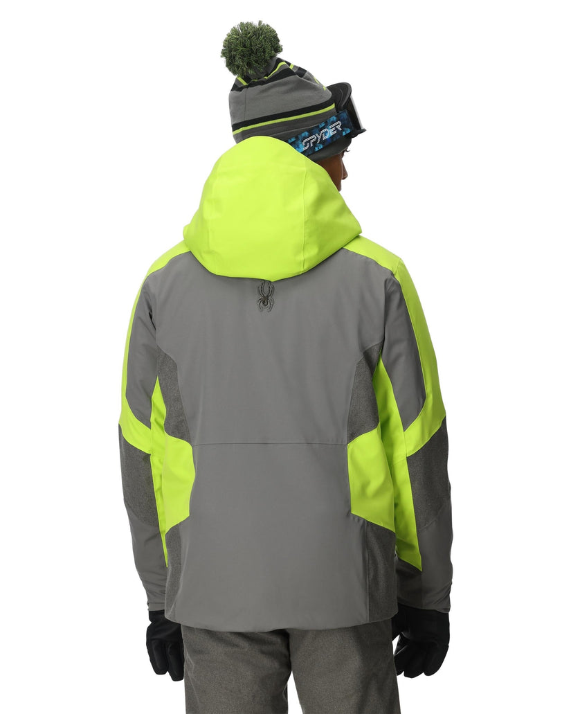 Person wearing a gray and neon green jacket with a white background