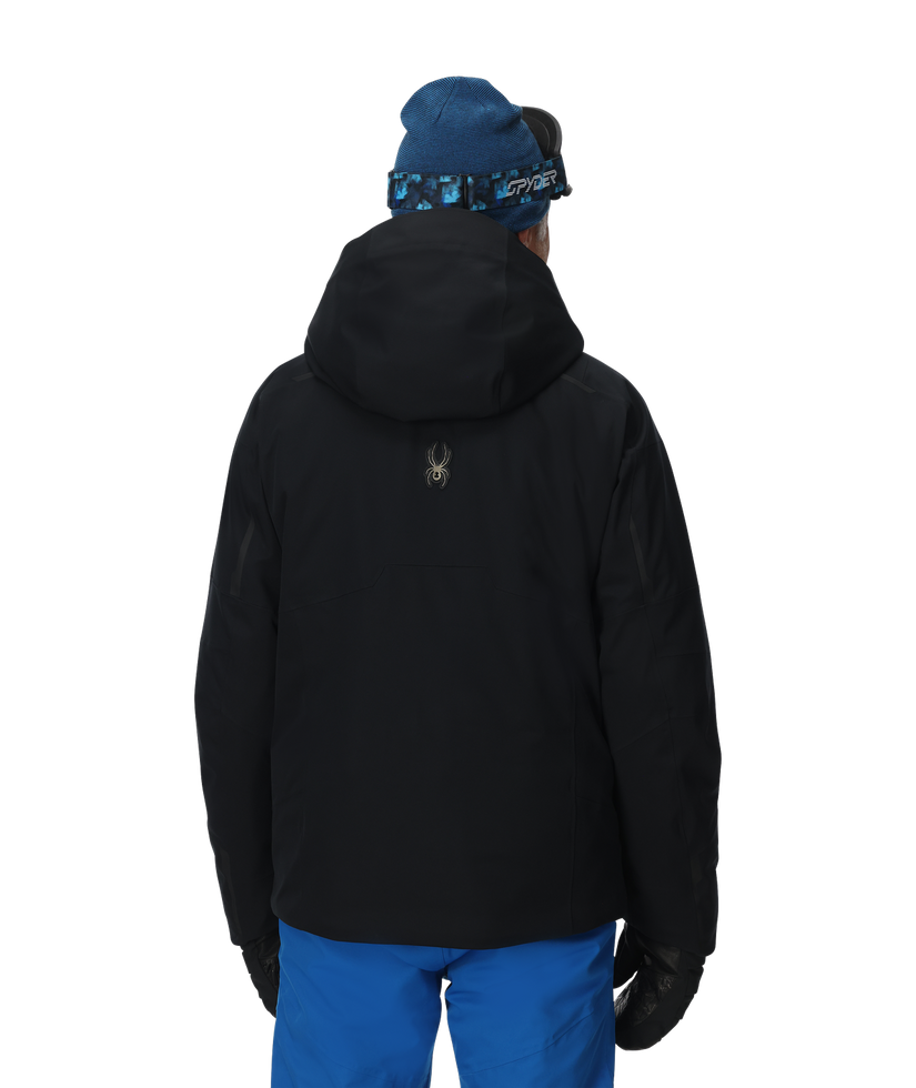 Person wearing a black jacket and blue pants with a blue beanie on a white background