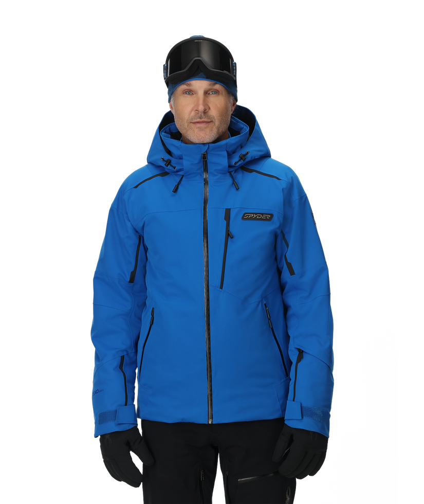 Man wearing a blue ski jacket with black accents on a white background