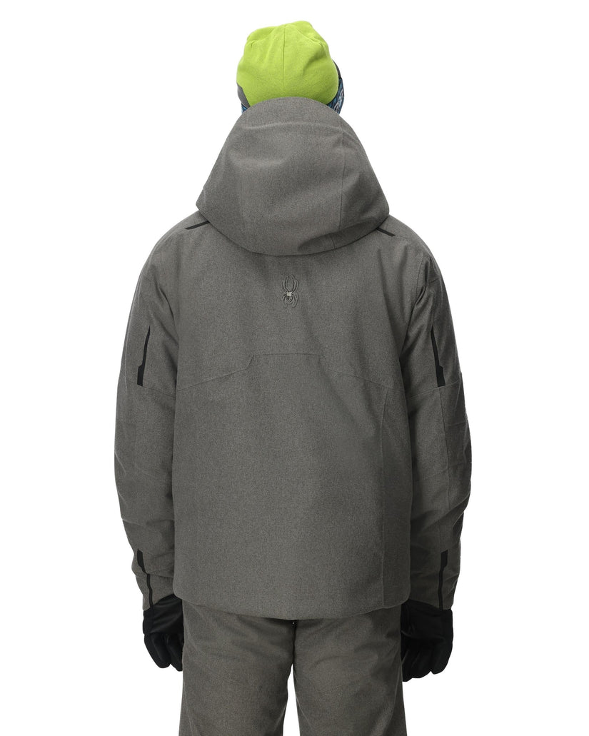 Person wearing a gray jacket and pants with a green hood on a white background