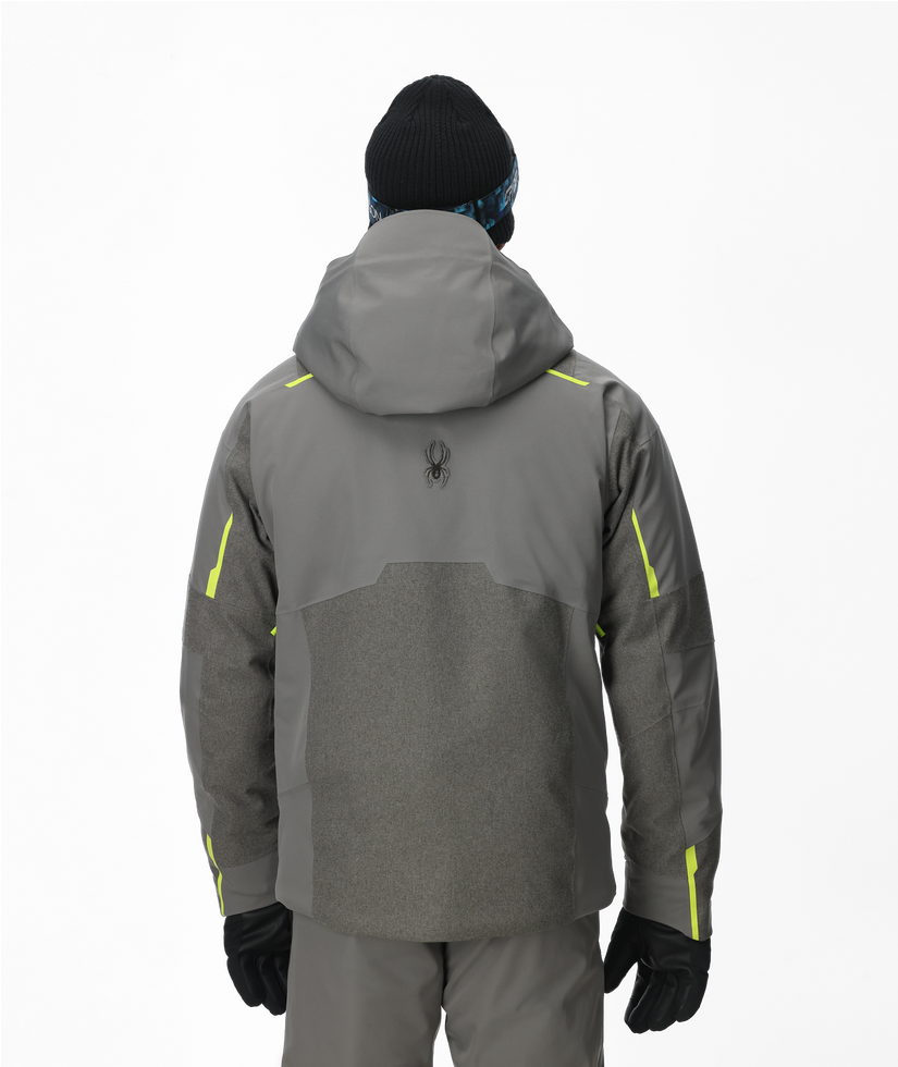 Person wearing a gray jacket with yellow accents on a white background