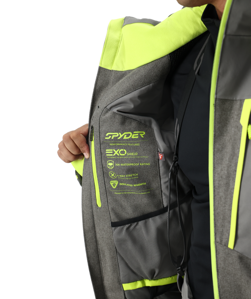 Gray and green Spyder jacket with visible branding and text on a white background