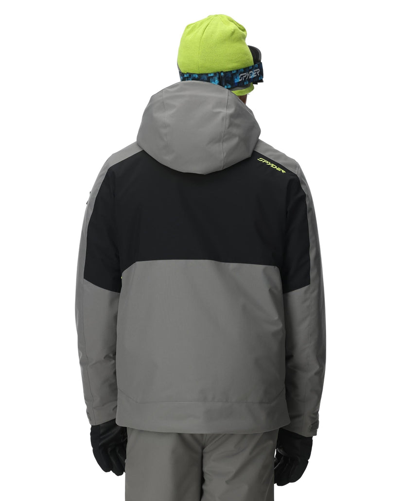 Person wearing a gray and black jacket with a hood on a white background