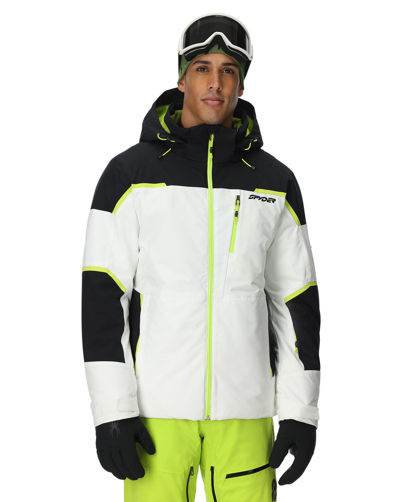 Person wearing a black, white, and neon green ski jacket with goggles on a white background