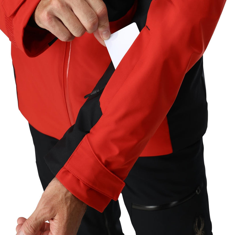 Red and black jacket with a person holding a white card.