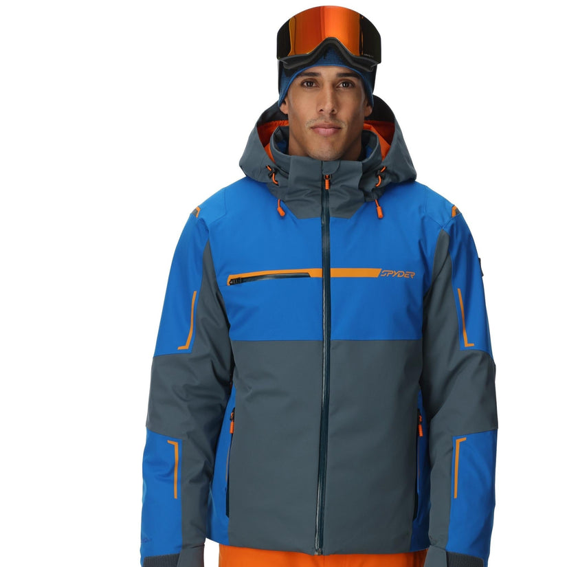 Person wearing a blue and gray jacket with orange accents on a white background