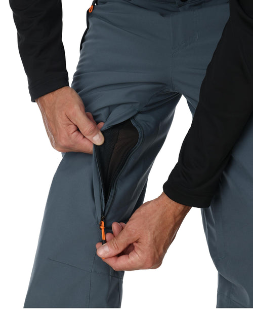 Person wearing blue pants with a black top on a white background