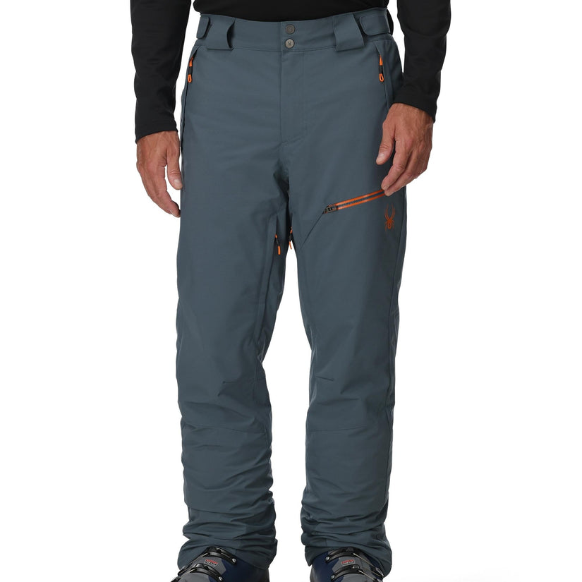 Person wearing blue pants with a black top on a white background