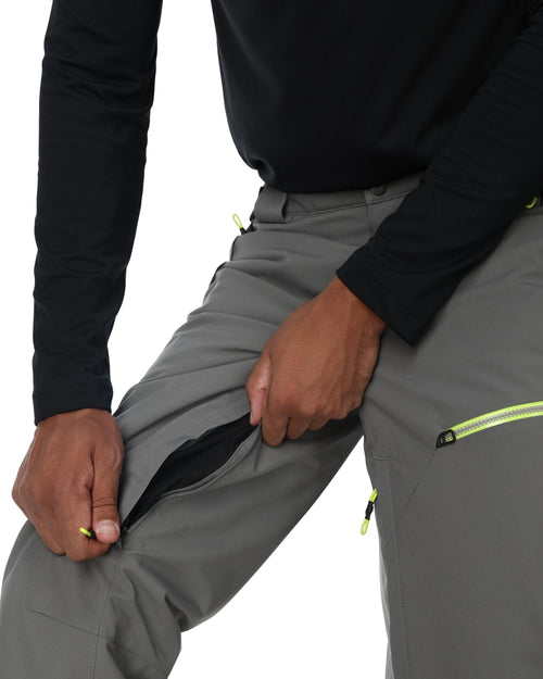 Gray pants with green accents worn by a person on a white background
