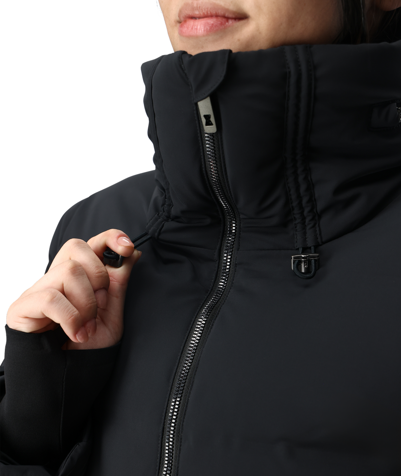 Close-up of a person wearing a black jacket with a hood.