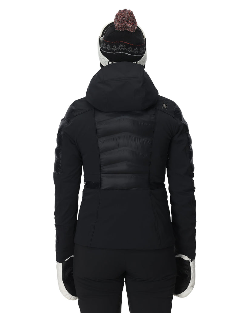 Person wearing a black winter coat with a hood on a white background