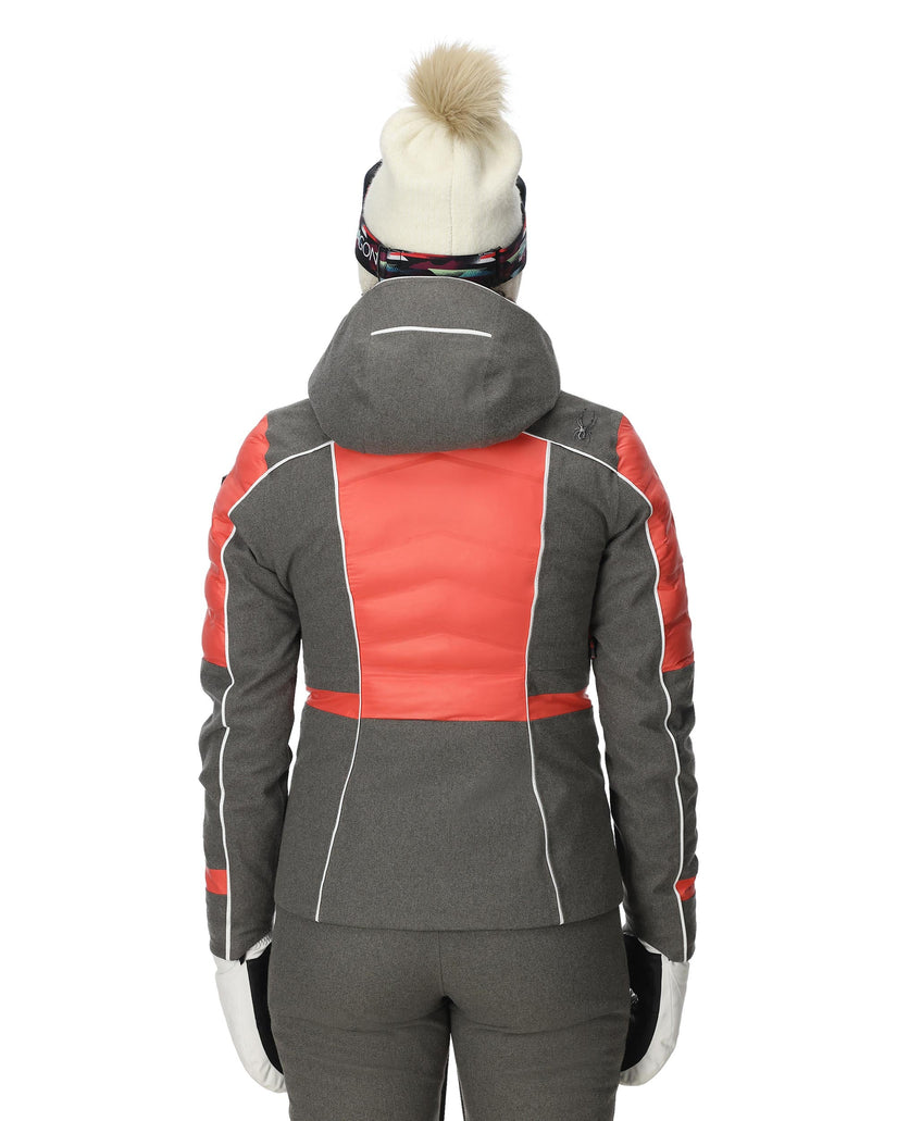 Person wearing a gray and red winter jacket with a white background