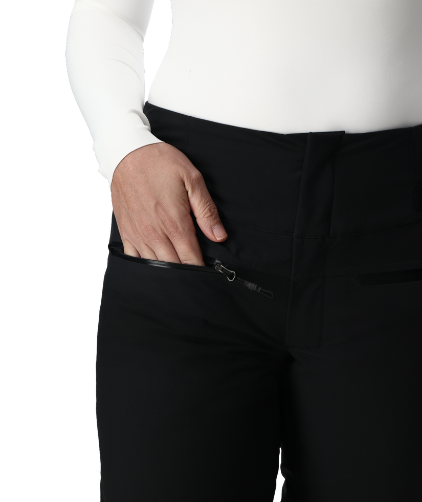 Person wearing black pants with a white shirt, focusing on the pants.