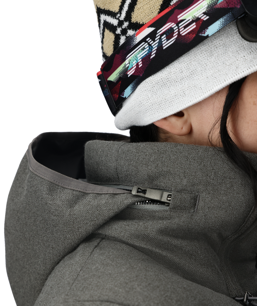 Person wearing a gray jacket with a brand logo on a white background