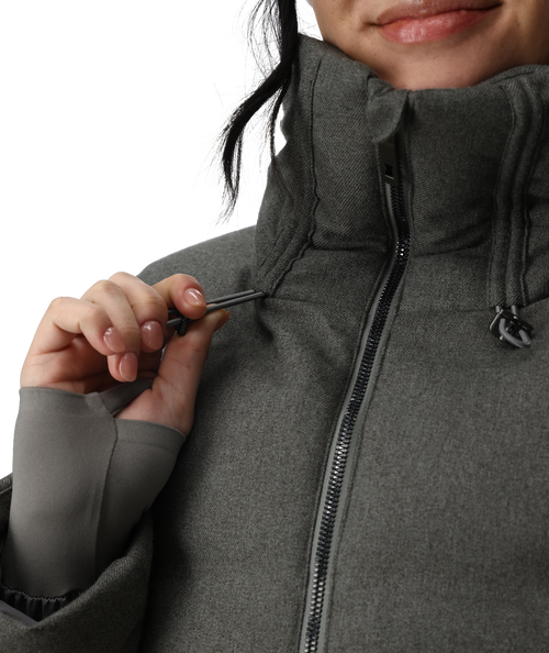 Person wearing a gray winter jacket, pants, gloves, and a beanie with goggles on a white background