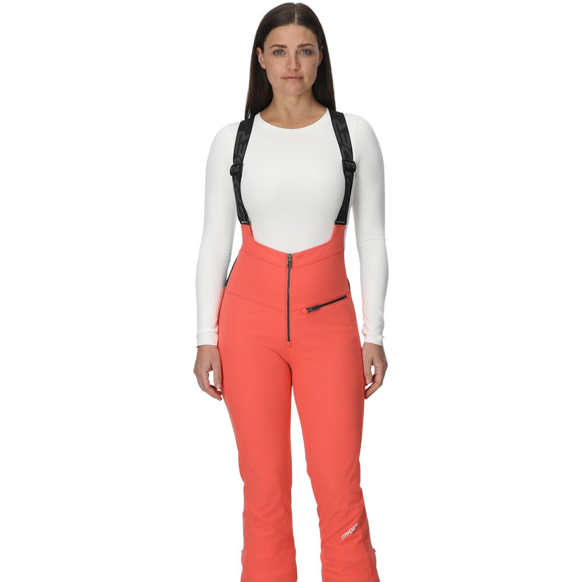Woman wearing red ski pants with suspenders on a white background