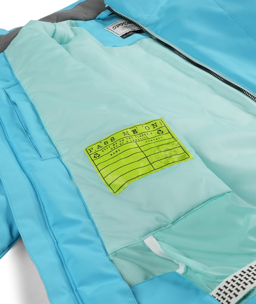 Close-up of a blue jacket with a green label on a white background