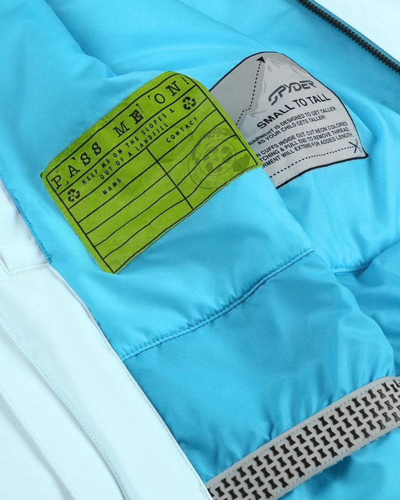 Close-up of a blue jacket with a green label and gray text on a white background